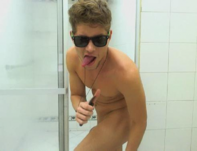 Blonde gay boy with sunglasses in the shower